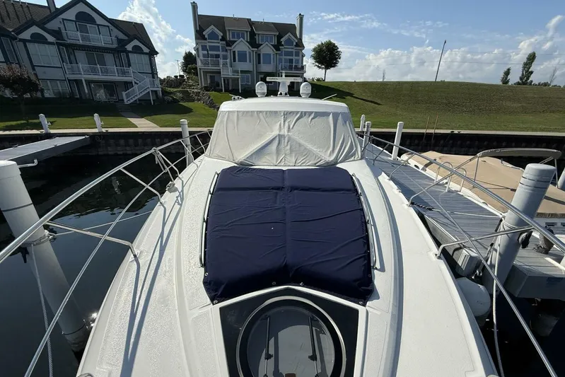  Yacht Photos Pics 2013 Cruisers Yachts Cantius docked near waterfront homes under a clear sky.