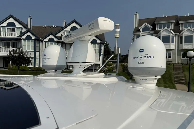  Yacht Photos Pics 2013 Cruisers Yachts Cantius with Garmin and TracVision equipment, docked near waterfront homes.