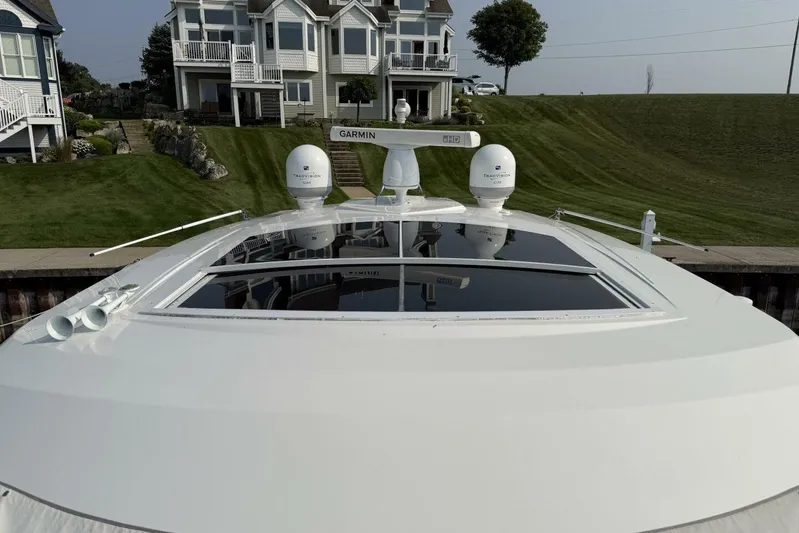  Yacht Photos Pics 2013 Cruisers Yachts Cantius with Garmin equipment, docked near waterfront homes.