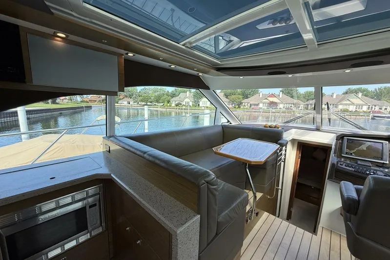  Yacht Photos Pics 2013 Cruisers Yachts Cantius interior with modern seating, navigation, and waterfront view.