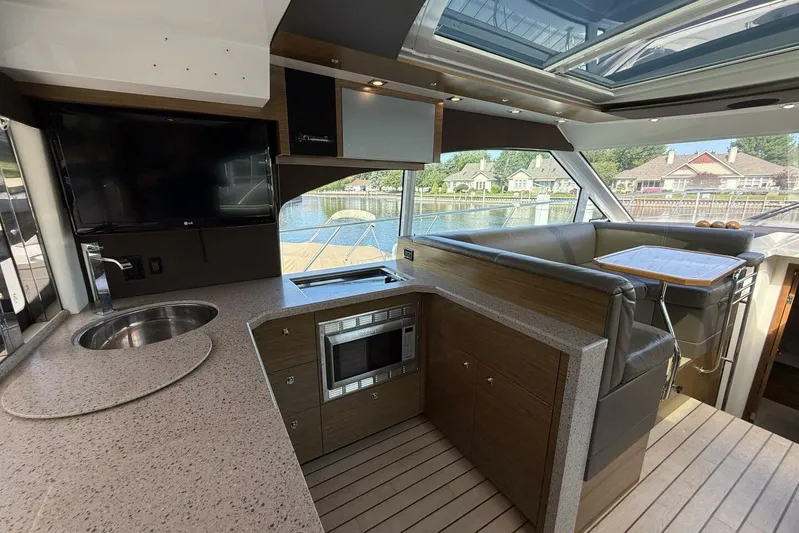  Yacht Photos Pics Luxurious 2013 Cruisers Yachts Cantius interior with modern kitchen and seating area.
