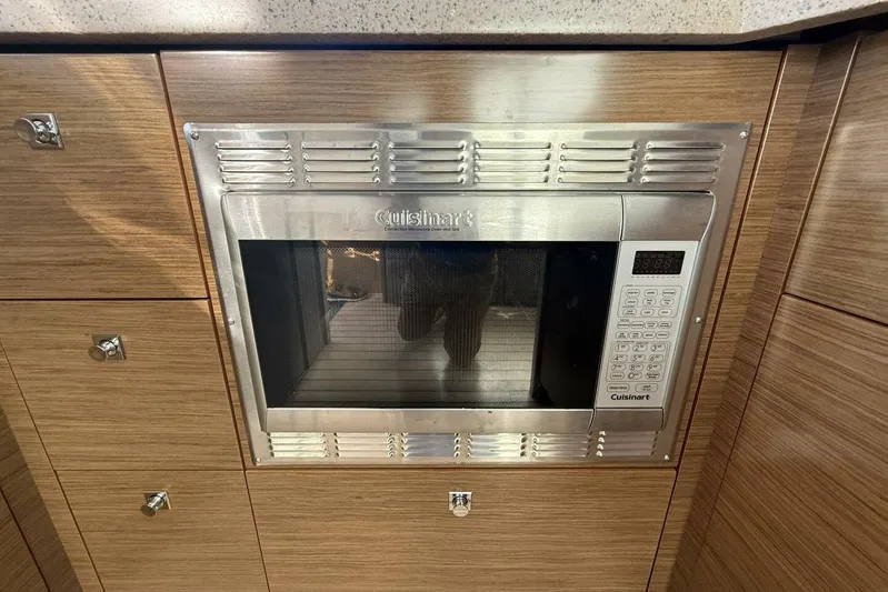  Yacht Photos Pics Built-in Cuisinart microwave in 2013 Cruisers Yachts Cantius kitchen, wood cabinetry.
