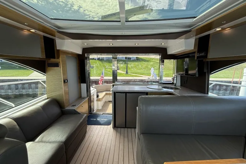  Yacht Photos Pics Luxurious interior of 2013 Cruisers Yachts Cantius with modern seating and panoramic windows.