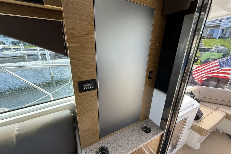  Yacht Photos Pics Interior of 2013 Cruisers Yachts Cantius with American flag and waterfront view.