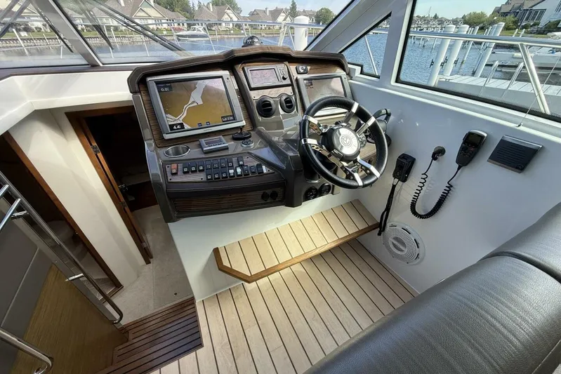  Yacht Photos Pics 2013 Cruisers Yachts Cantius helm with navigation screens and controls, dockside view.