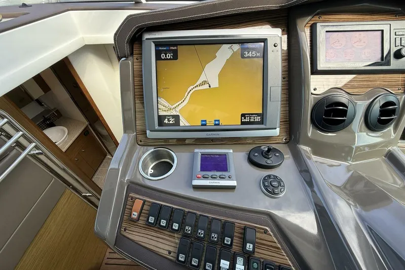  Yacht Photos Pics 2013 Cruisers Yachts Cantius helm with Garmin navigation system and control panel.