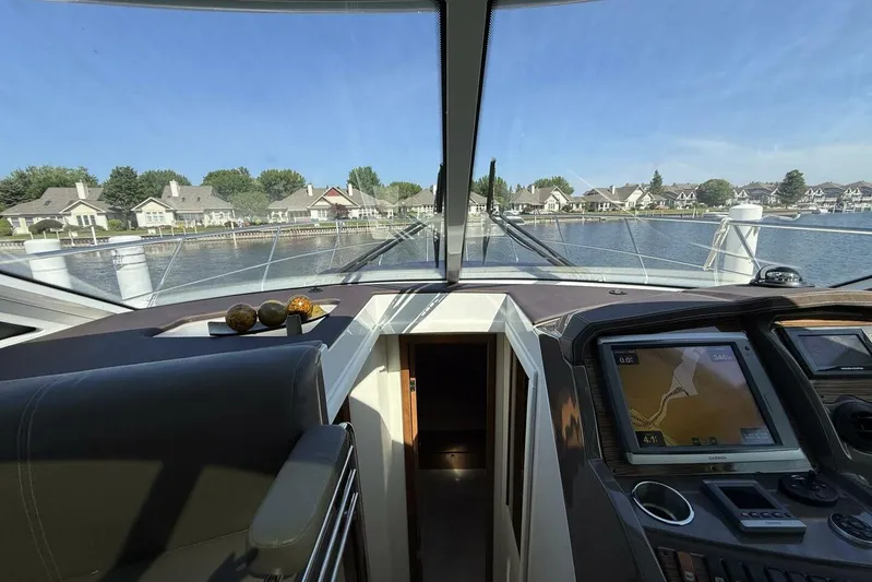  Yacht Photos Pics Interior view of 2013 Cruisers Yachts Cantius, featuring navigation system and waterfront homes.