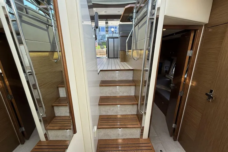 Yacht Photos Pics Interior of 2013 Cruisers Yachts Cantius, featuring wooden stairs and modern design elements.