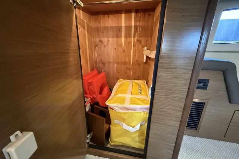  Yacht Photos Pics Storage compartment in 2013 Cruisers Yachts Cantius with life jackets and safety equipment.