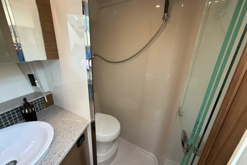  Yacht Photos Pics 2013 Cruisers Yachts Cantius bathroom with shower, sink, and modern fixtures.