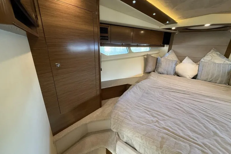 Yacht Photos Pics Luxurious 2013 Cruisers Yachts Cantius bedroom with elegant wood finishes and cozy bedding.
