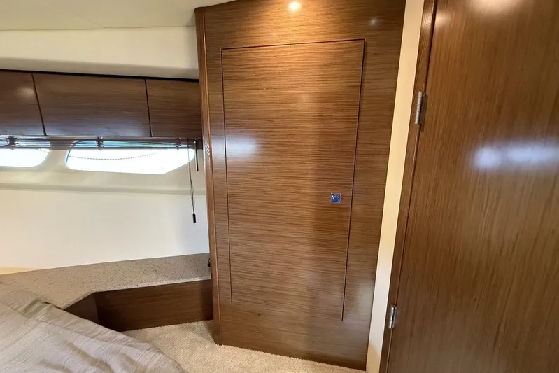  Yacht Photos Pics Interior of 2013 Cruisers Yachts Cantius with wooden cabinetry and windows.