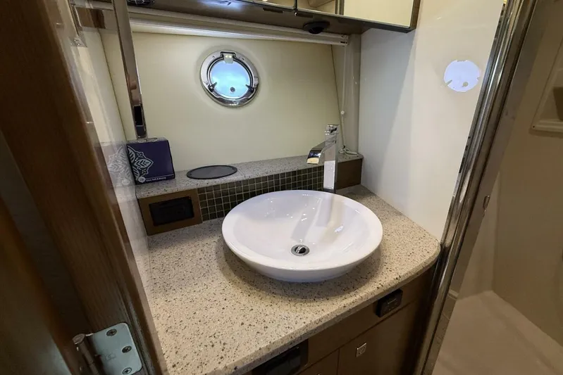  Yacht Photos Pics 2013 Cruisers Yachts Cantius bathroom with modern sink and porthole window.