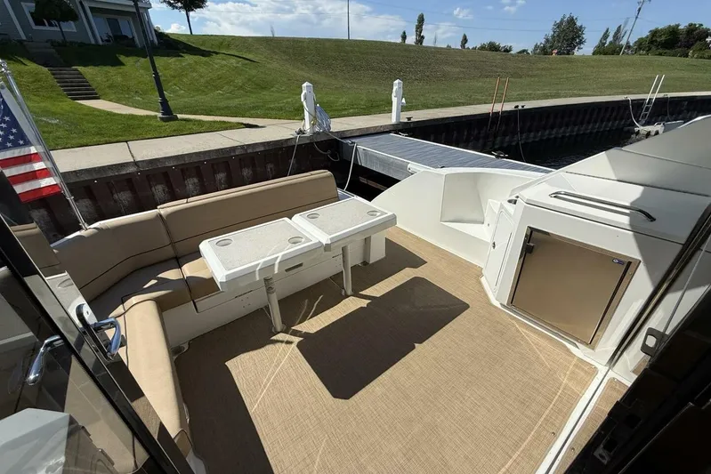  Yacht Photos Pics 2013 Cruisers Yachts Cantius deck with seating, tables, and outdoor fridge.
