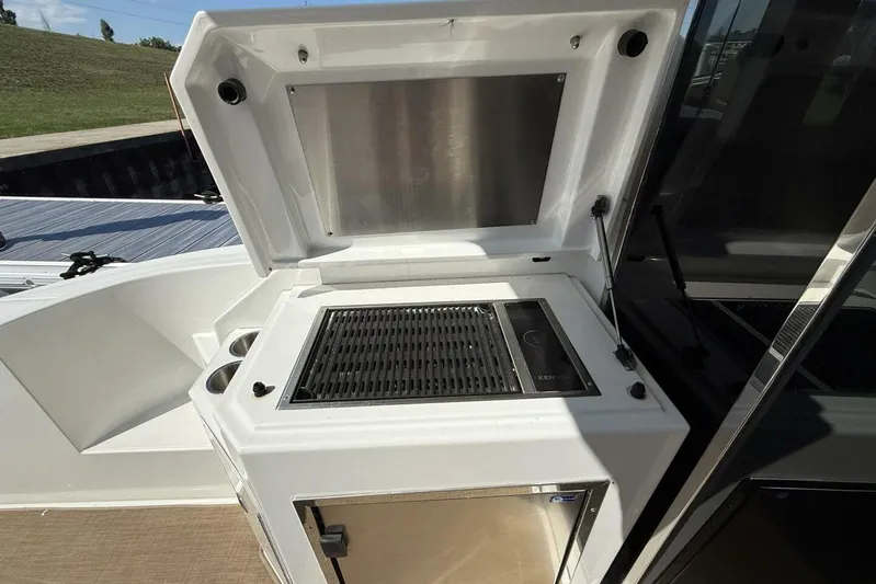  Yacht Photos Pics Outdoor grill on 2013 Cruisers Yachts Cantius, featuring sleek design and modern amenities.