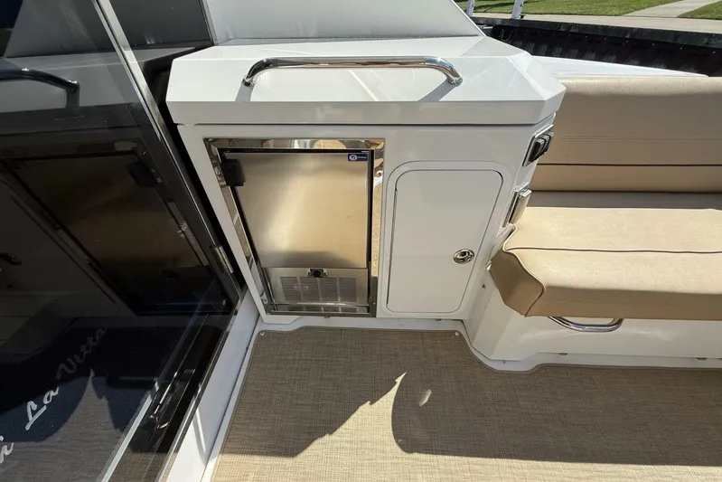 Yacht Photos Pics 2013 Cruisers Yachts Cantius interior with mini fridge and beige seating.