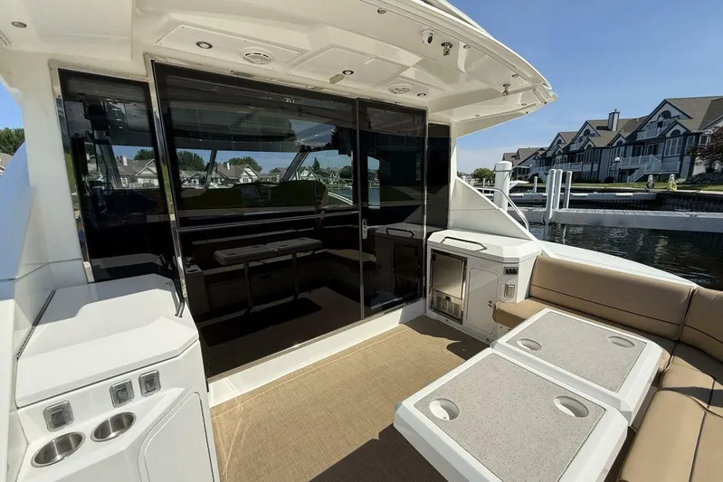  Yacht Photos Pics 2013 Cruisers Yachts Cantius deck with seating, table, and waterfront view.