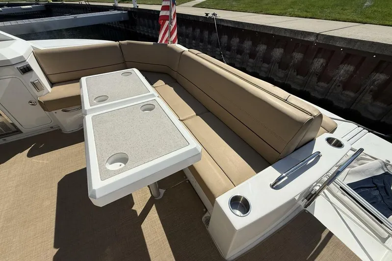  Yacht Photos Pics 2013 Cruisers Yachts Cantius seating area with beige cushions and dual tables.