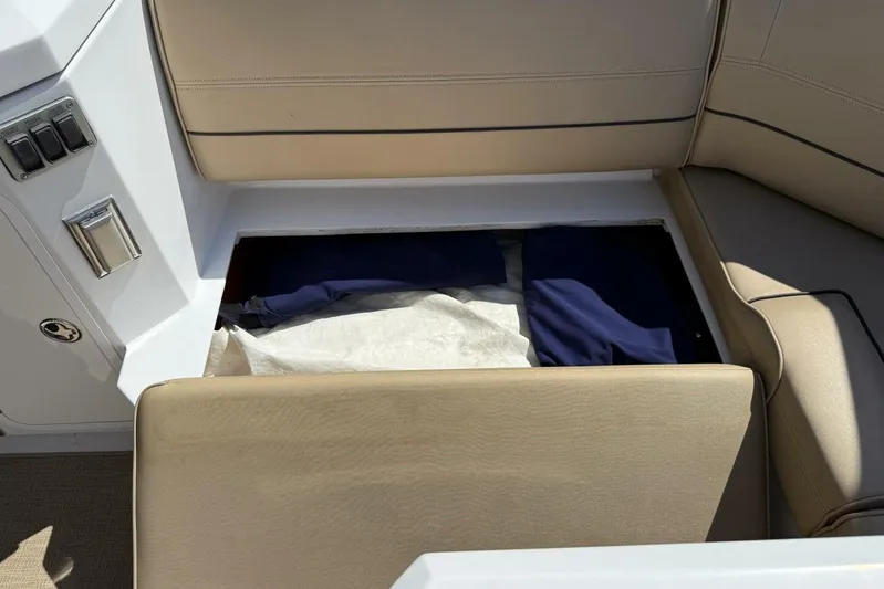  Yacht Photos Pics 2013 Cruisers Yachts Cantius storage compartment with beige seating and hidden items.