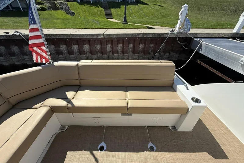  Yacht Photos Pics 2013 Cruisers Yachts Cantius with beige seating and American flag at dockside.