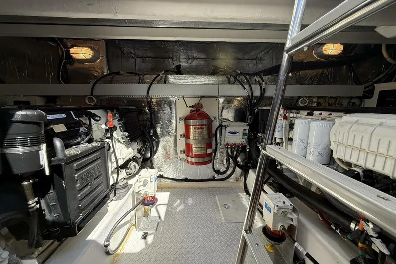  Yacht Photos Pics Engine room of 2013 Cruisers Yachts Cantius, featuring mechanical equipment and fire extinguisher.