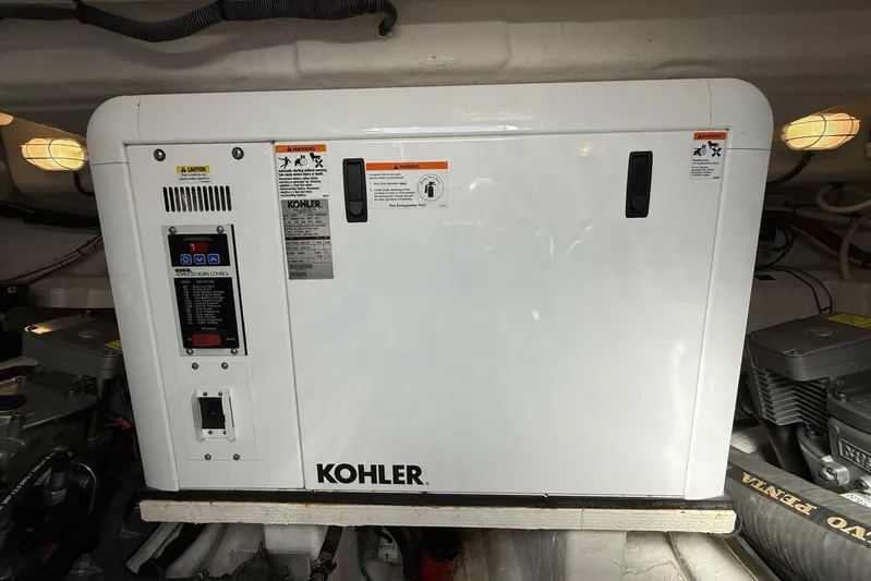  Yacht Photos Pics Kohler generator in 2013 Cruisers Yachts Cantius engine room, showcasing marine power equipment.