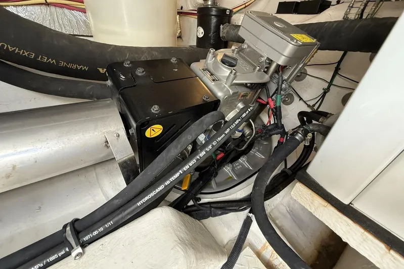  Yacht Photos Pics Engine compartment of 2013 Cruisers Yachts Cantius with visible hoses and components.