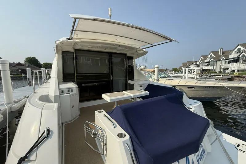 Yacht Photos Pics 2013 Cruisers Yachts Cantius docked, featuring spacious deck and seating area.