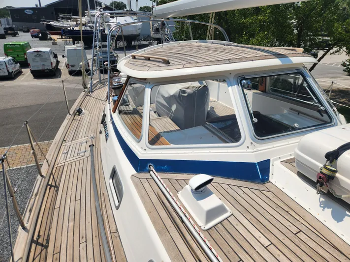 Sonder Yacht Photos Pics 2003 Hallberg-Rassy 46 sailboat with teak deck and spacious cockpit, docked at marina.