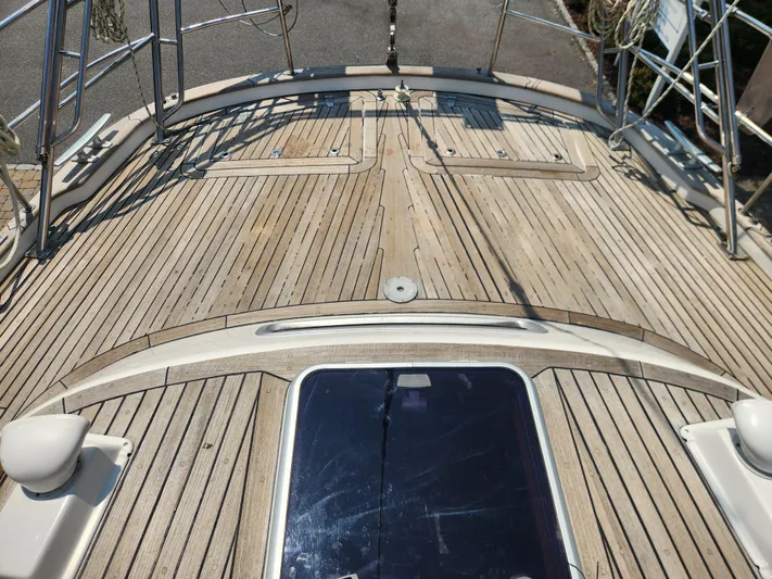 Sonder Yacht Photos Pics Deck of a 2003 Hallberg-Rassy 46 sailboat with teak wood finish.