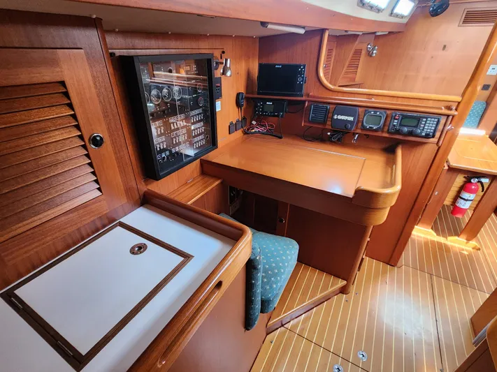 Sonder Yacht Photos Pics Interior of 2003 Hallberg-Rassy 46 yacht with navigation equipment and wooden finish.