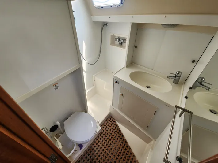 Sonder Yacht Photos Pics Bathroom interior of 2003 Hallberg-Rassy 46 yacht, featuring sink, toilet, and shower.