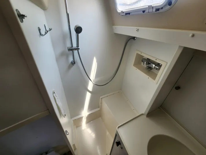 Sonder Yacht Photos Pics Bathroom interior of 2003 Hallberg-Rassy 46 yacht, featuring shower and sink.