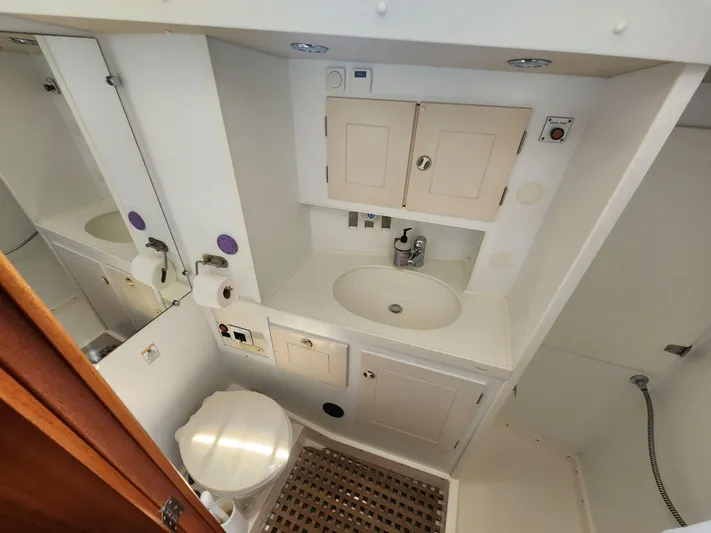 Sonder Yacht Photos Pics Bathroom interior of 2003 Hallberg-Rassy 46 yacht, featuring sink, toilet, and storage cabinets.