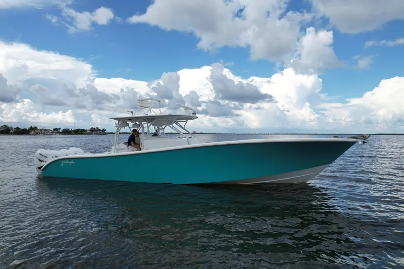  Yacht Photos Pics 2009 Yellowfin 42 Offshore boat on calm water under a cloudy sky.
