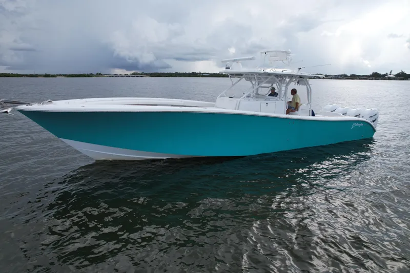  Yacht Photos Pics 2009 Yellowfin 42 Offshore boat on calm water under cloudy sky.