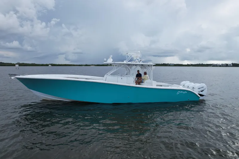  Yacht Photos Pics 2009 Yellowfin 42 Offshore boat on calm water under cloudy sky.