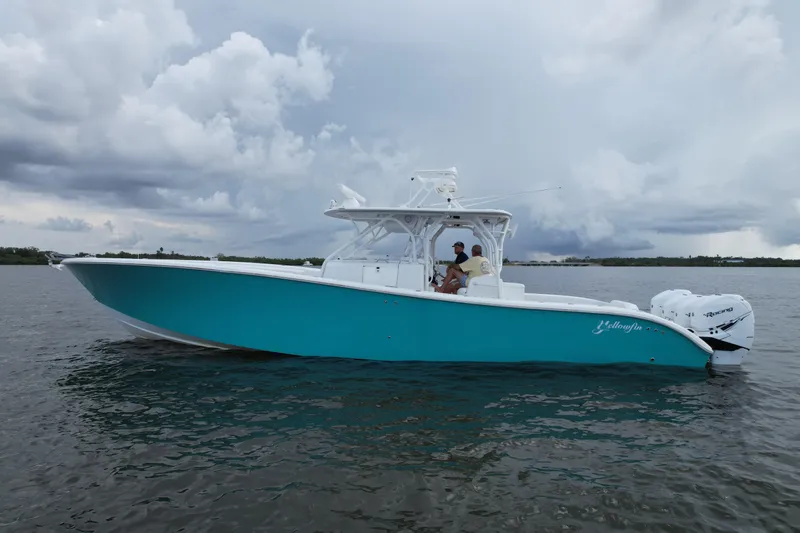  Yacht Photos Pics 2009 Yellowfin 42 Offshore boat on water under cloudy sky.