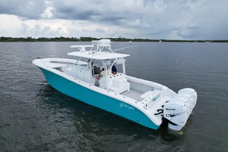  Yacht Photos Pics 2009 Yellowfin 42 Offshore boat with triple engines on calm water.