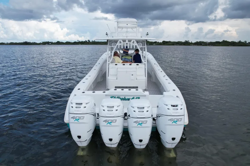  Yacht Photos Pics 2009 Yellowfin 42 Offshore boat with four powerful outboard engines on calm water.