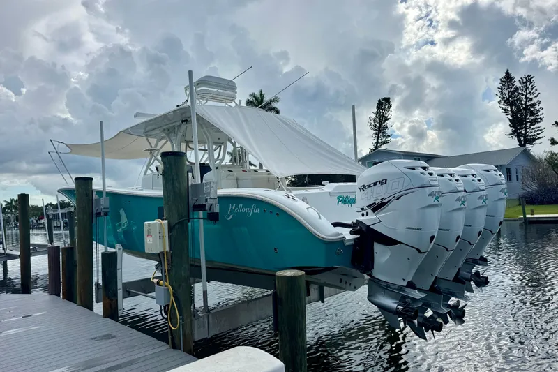  Yacht Photos Pics 2009 Yellowfin 42 Offshore boat with quad engines docked under cloudy skies.
