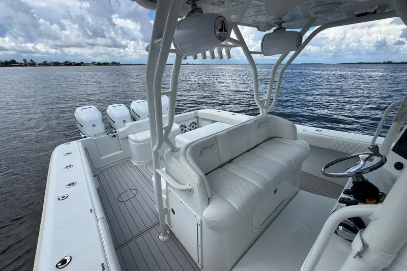  Yacht Photos Pics 2009 Yellowfin 42 Offshore boat interior with white seating and multiple outboard engines.