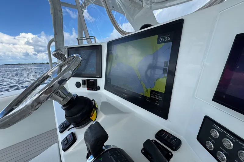  Yacht Photos Pics 2009 Yellowfin 42 Offshore boat dashboard with navigation screens and steering wheel.