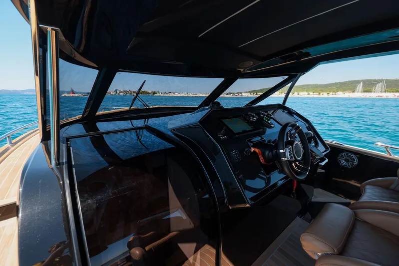  Yacht Photos Pics 2025 Focus Forza 37 yacht cockpit with modern controls, steering wheel, and ocean view.