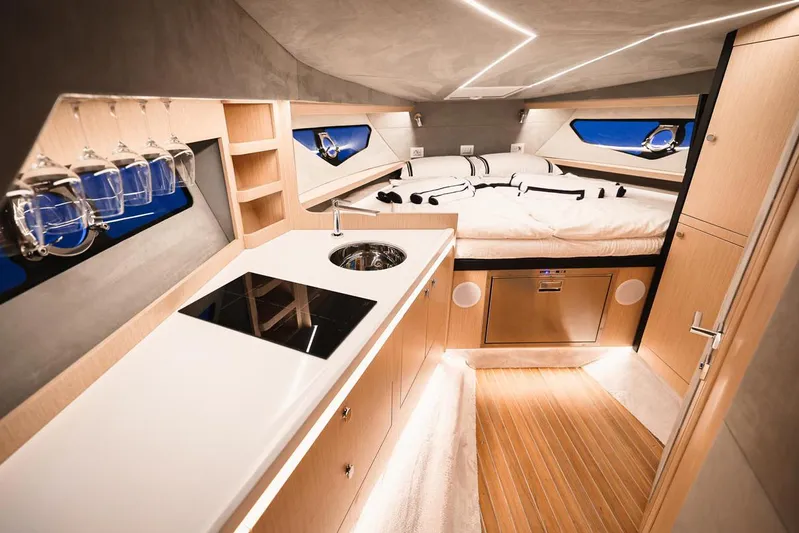 Yacht Photos Pics Luxurious interior of 2025 Focus Forza 37 yacht with modern kitchen and cozy sleeping area.