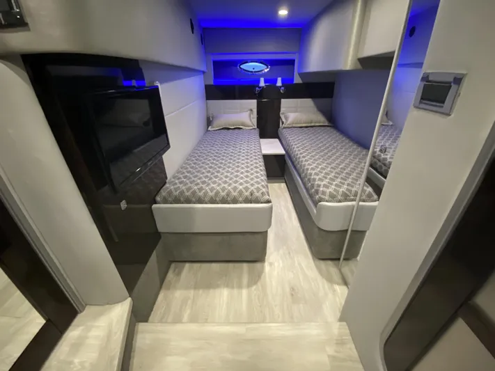  Yacht Photos Pics Interior of 2018 Formula 45 Yacht with twin beds and blue lighting.