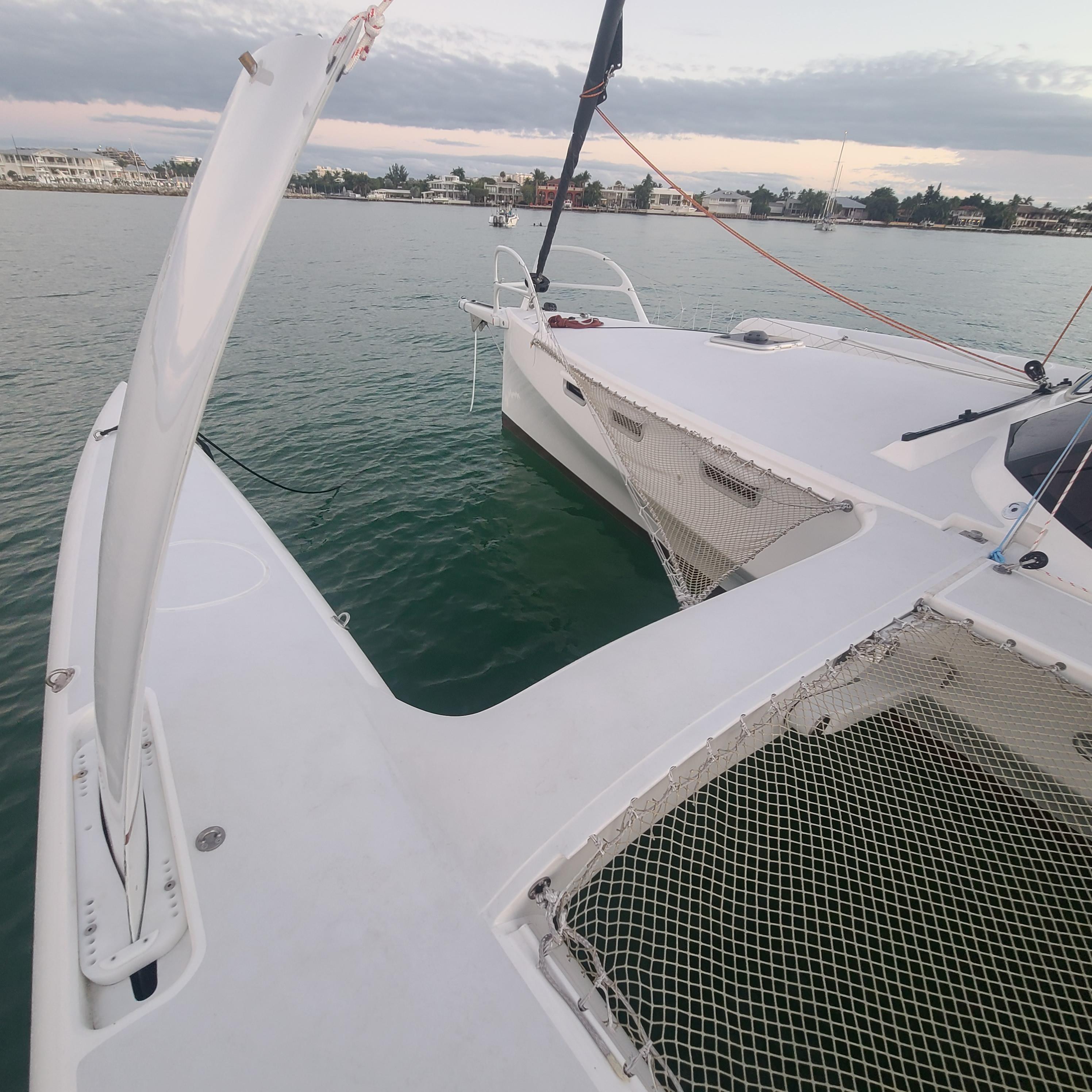 2025 Rapido 40 trimaran on calm water, showcasing sleek design and netted deck.