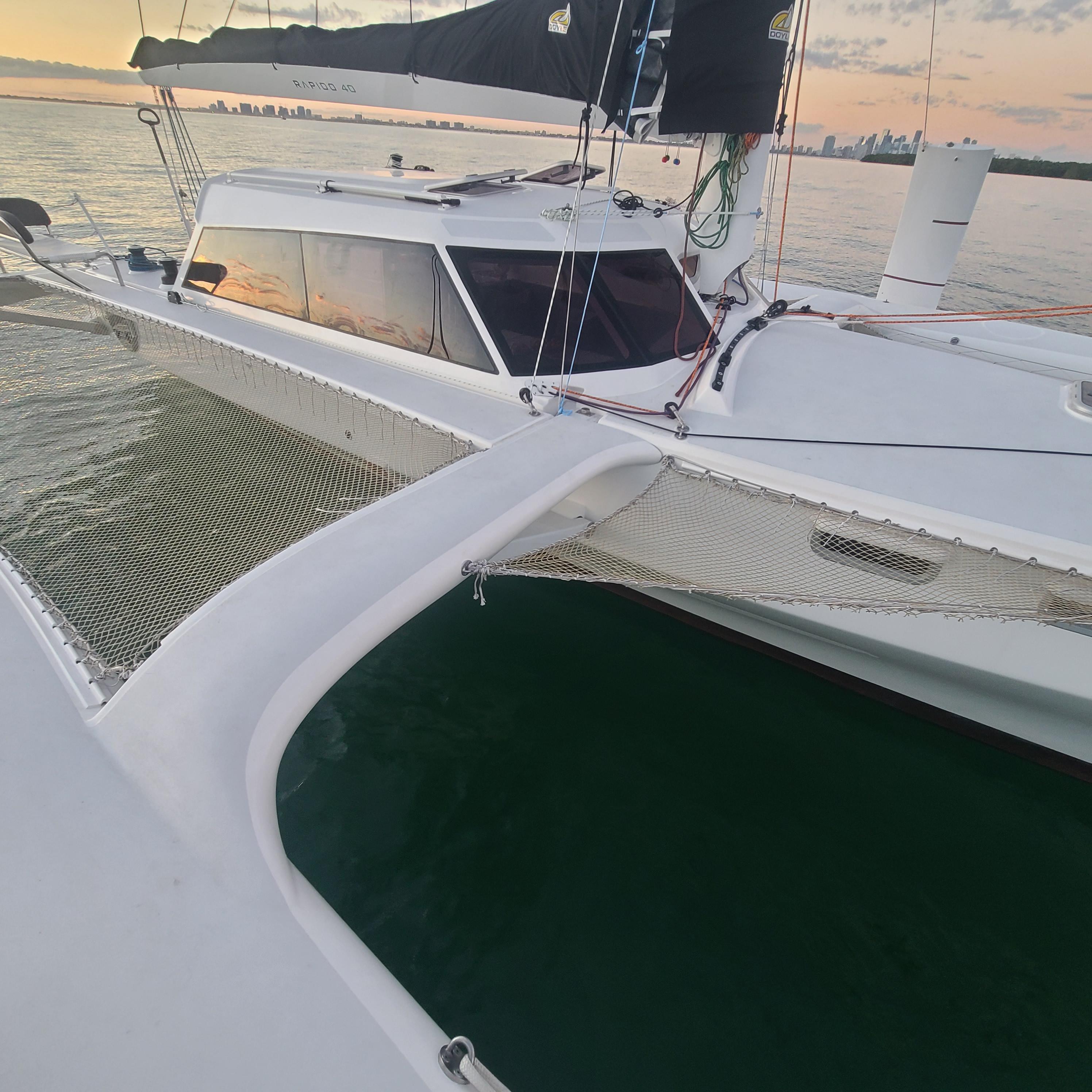 2025 Rapido 40 catamaran on calm water at sunset.