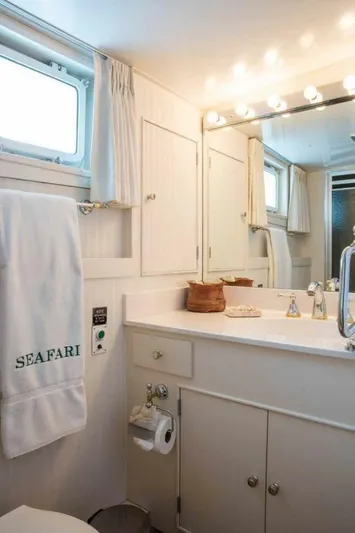 Seafari Yacht Photos Pics Luxurious bathroom on 1975 Burger Raised Pilothouse CPMY yacht with elegant fixtures and lighting.