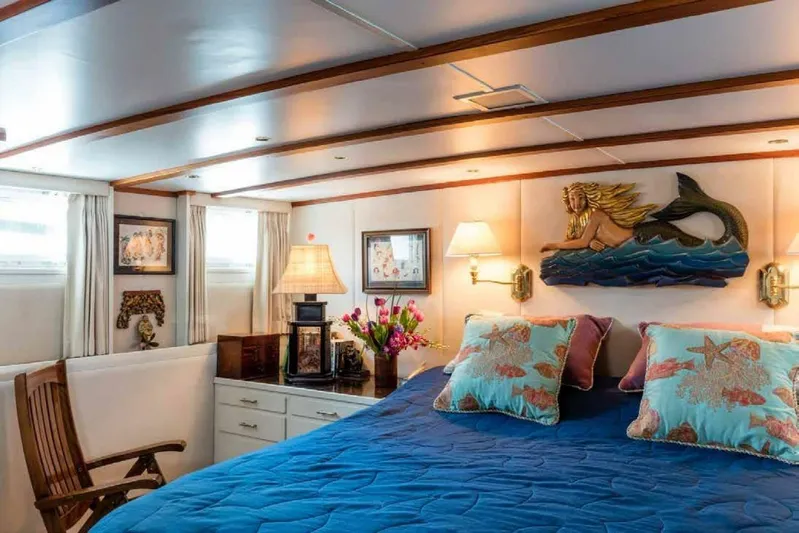 Seafari Yacht Photos Pics Luxurious 1975 Burger Raised Pilothouse CPMY yacht bedroom with nautical decor and elegant furnishings.